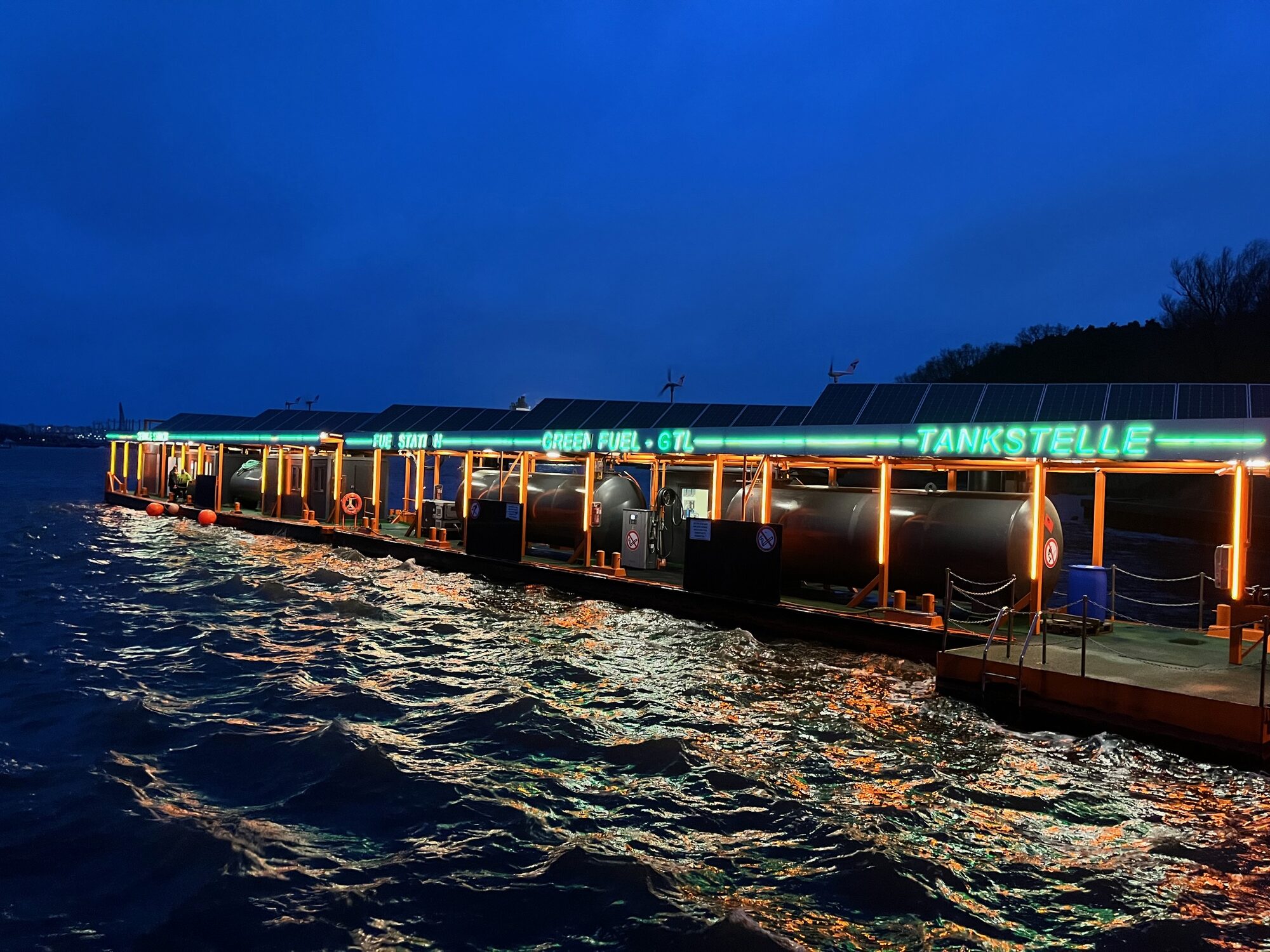 Beleuchteter Tankstellenponton bei Nacht